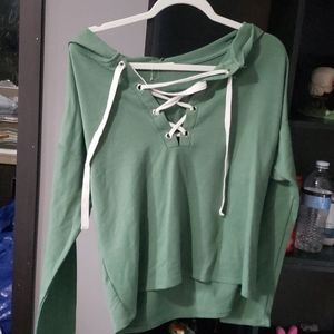 Green sweater with white tie up in front